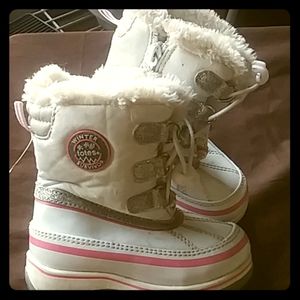 Little girl totes snowboots